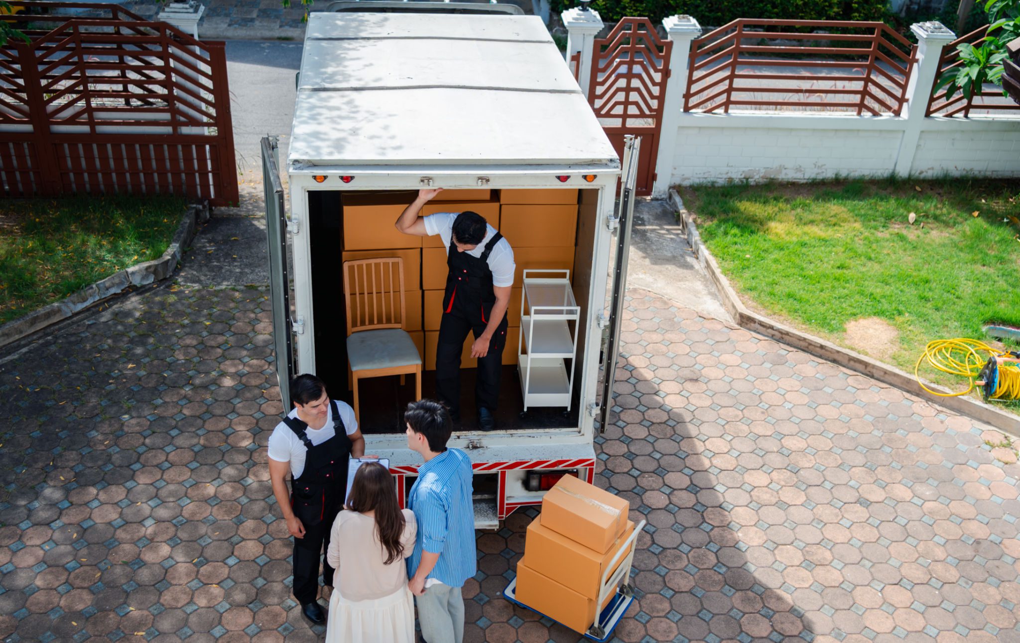 People moving furniture into a truck.